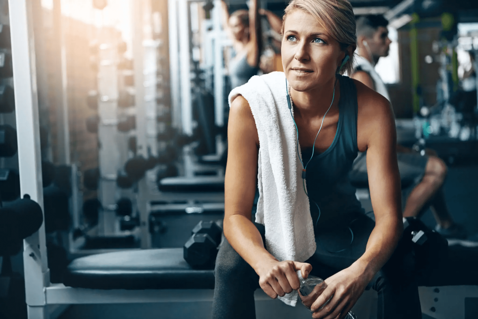 A woman sitting on the floor in a gym