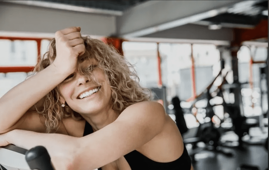 A woman is smiling in the gym