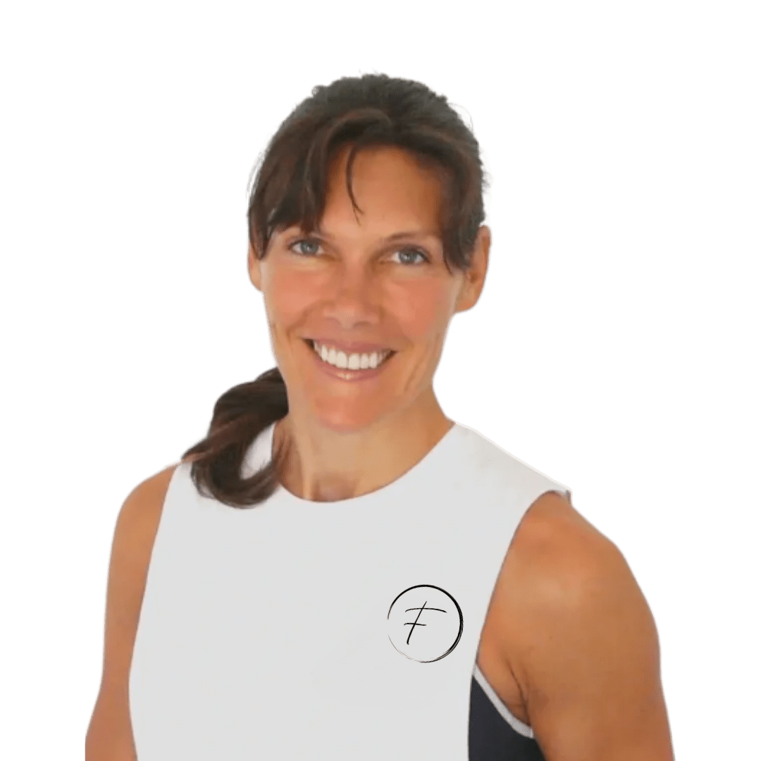 A woman in white shirt and black vest smiling.
