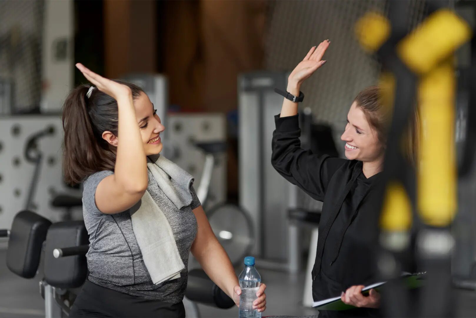 Two women are having fun in a gym.