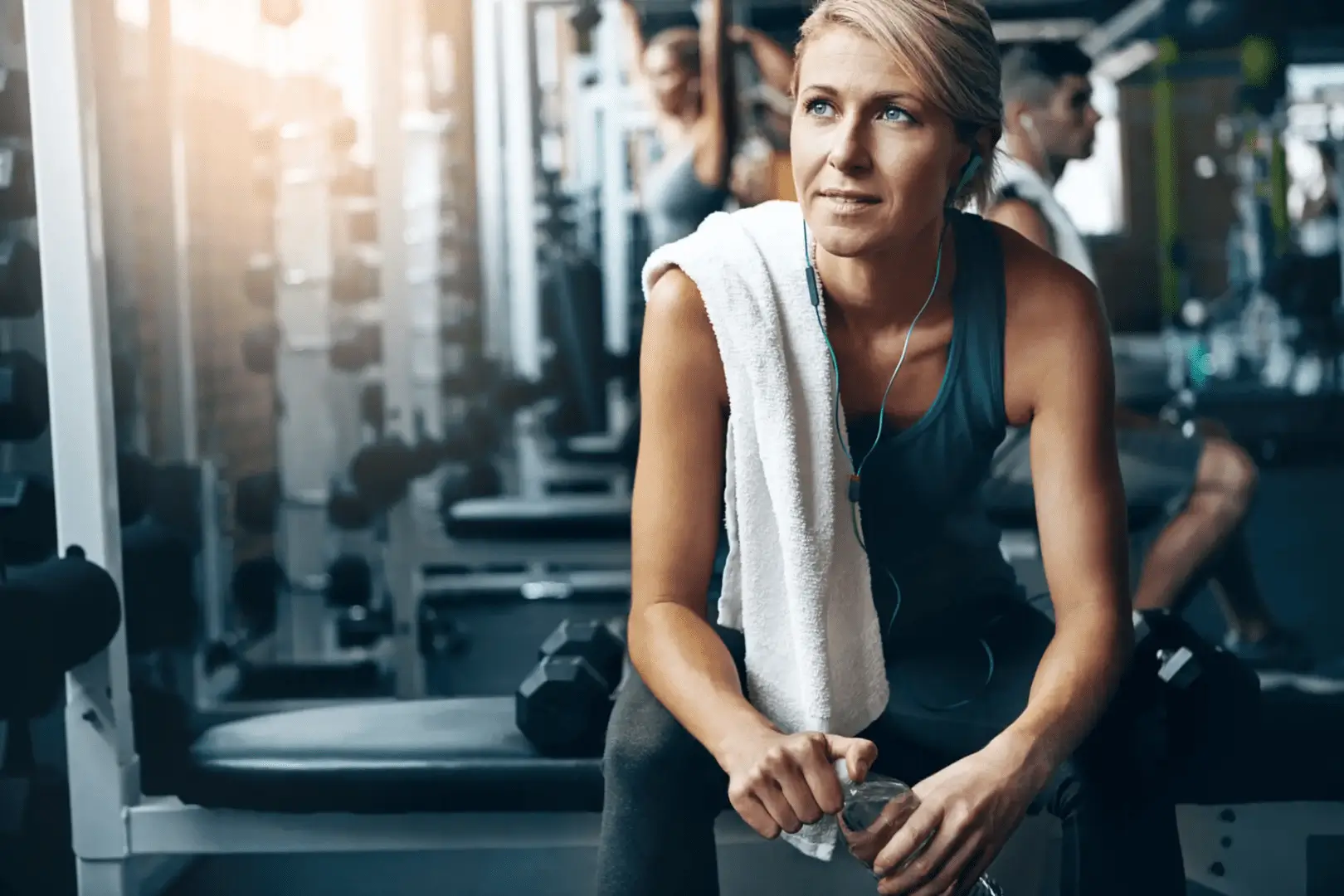 A woman sitting on the floor in a gym